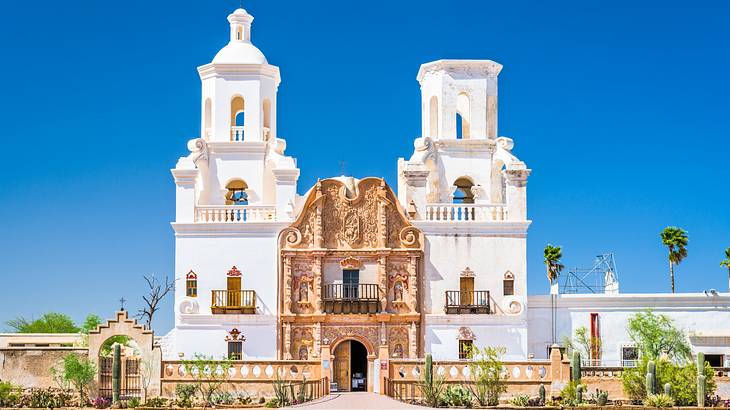 A red church building with two white towers and a gold entrance