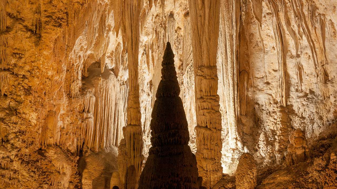 Stalactites and stalagmites inside an illuminated cave