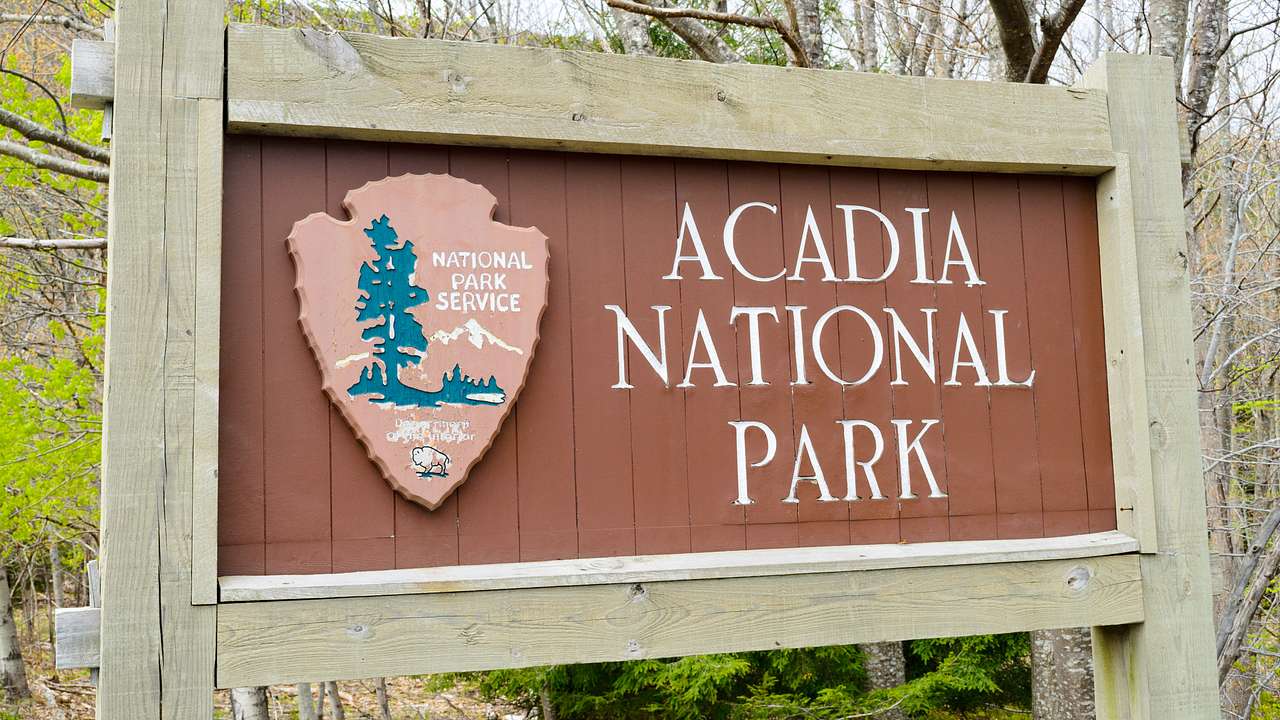 A sign on a wooden fence "Acadia National Park"