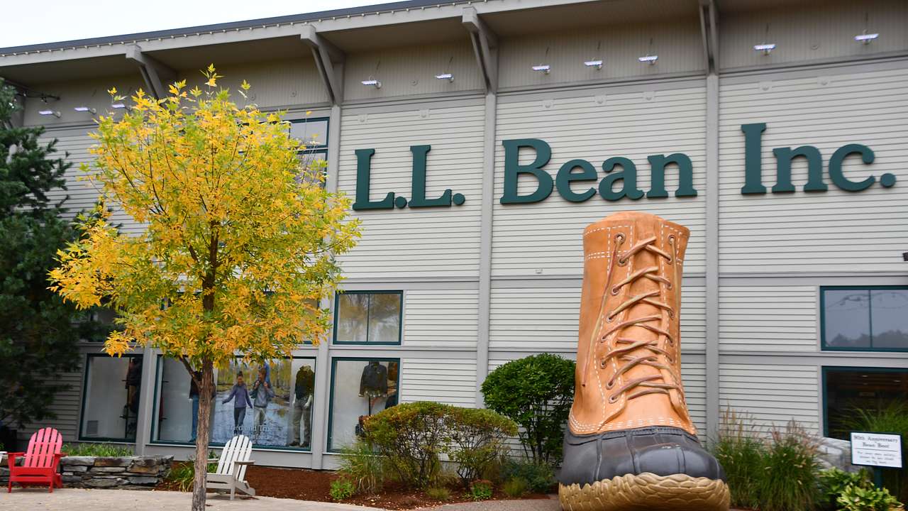 A light-colored building with the sign "L.L. Bean" and a large boot in front of it