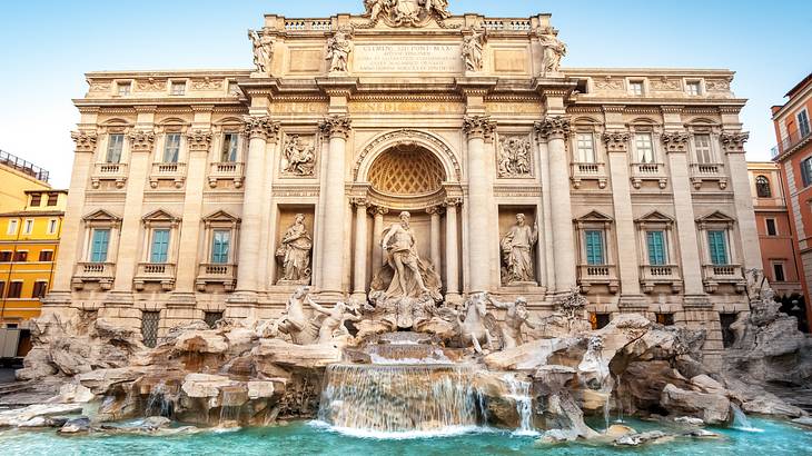 Trevi Fountain with waterfall in front of a big building, Rome, Italy Trevi Fountain with waterfall in front of a big building, Rome, Italy