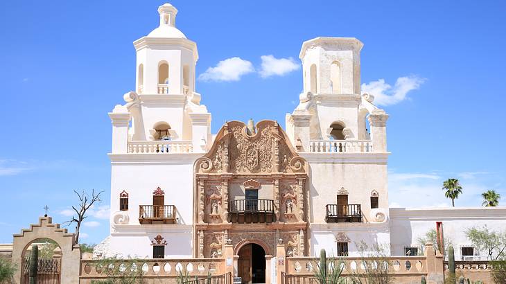 A white church with a bell tower and an embellished entrance
