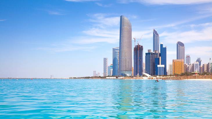 Tall city buildings from Corniche Beach, one of the best beaches in Abu Dhabi