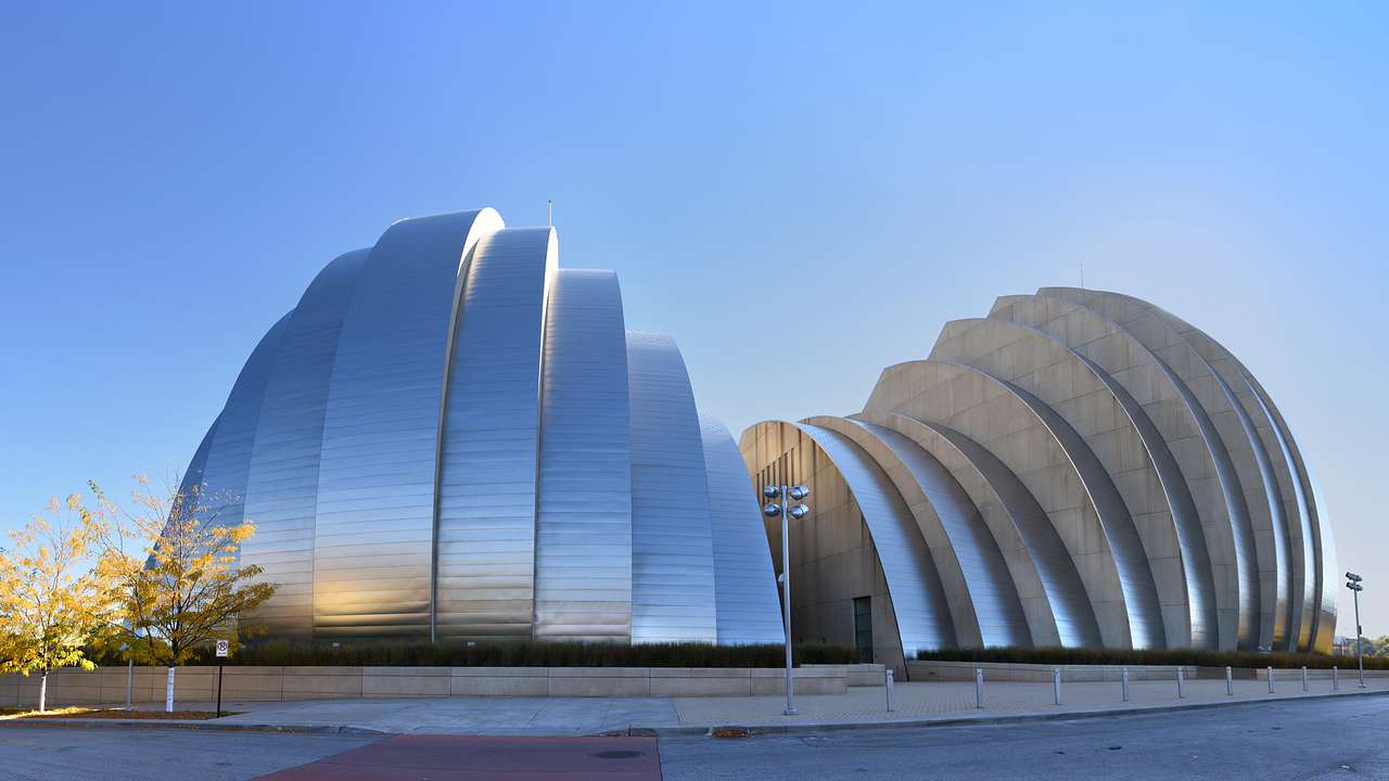 A modernist-style, dome-shaped steel structure next to a blue sky