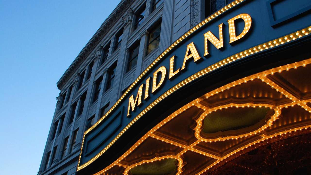 A building with a black awning and an illuminated sign that says "Midland"