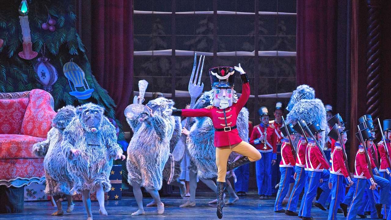 A ballet performance of The Nutcracker with people in toy soldier and mice costumes