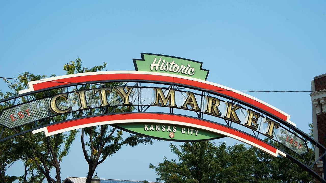 A red, green, and white sign that says "Historic City Market" on it
