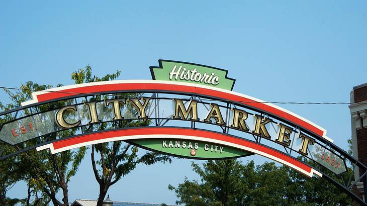 A red, green, and white sign that says "Historic City Market" on it