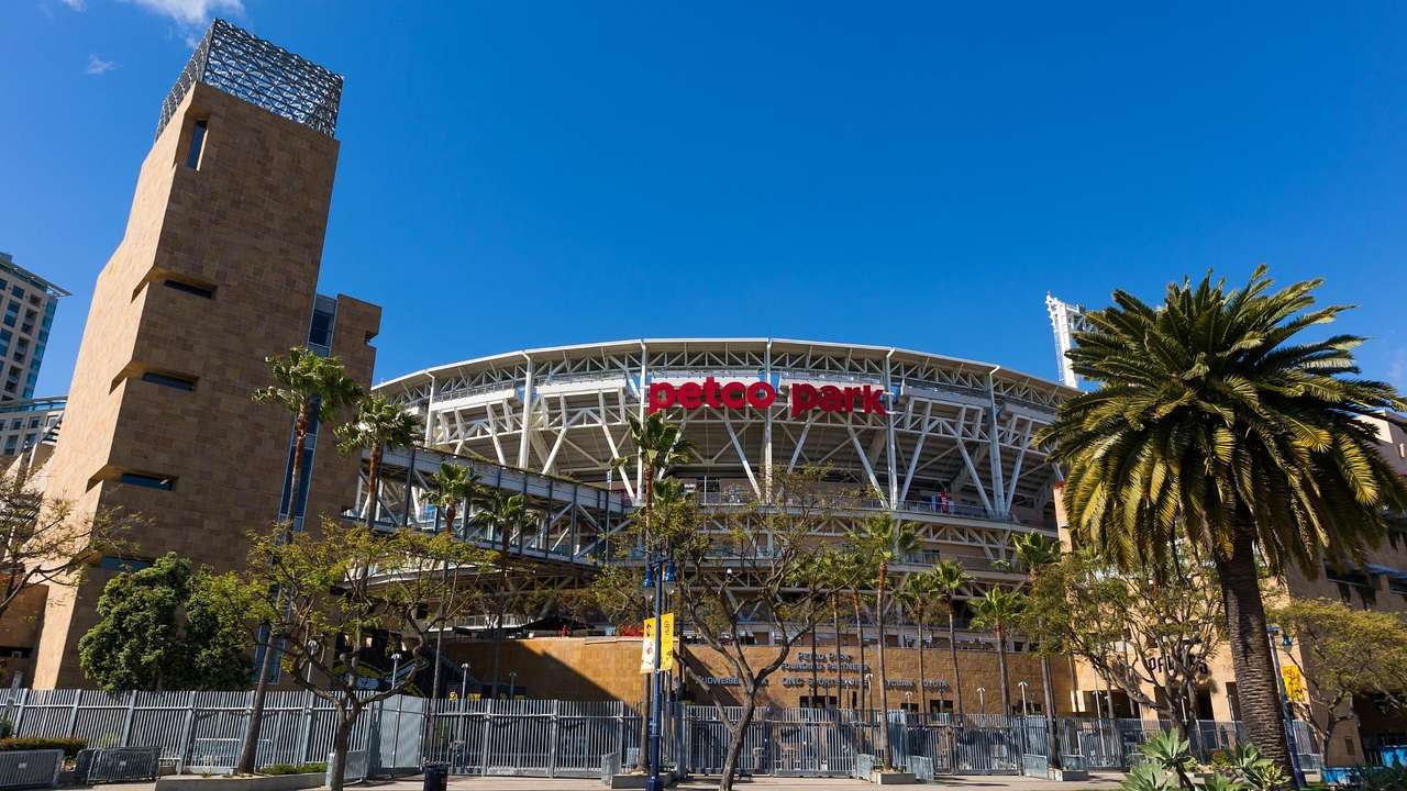 A sports stadium with a "Petco Park" sign and palm trees in front of it
