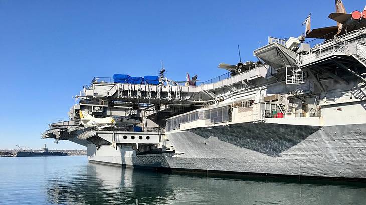 An aircraft carrier on the water on a clear day