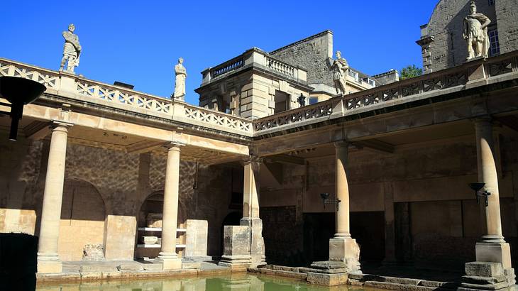 A bottom up view of the Roman Baths with stone monuments at the top
