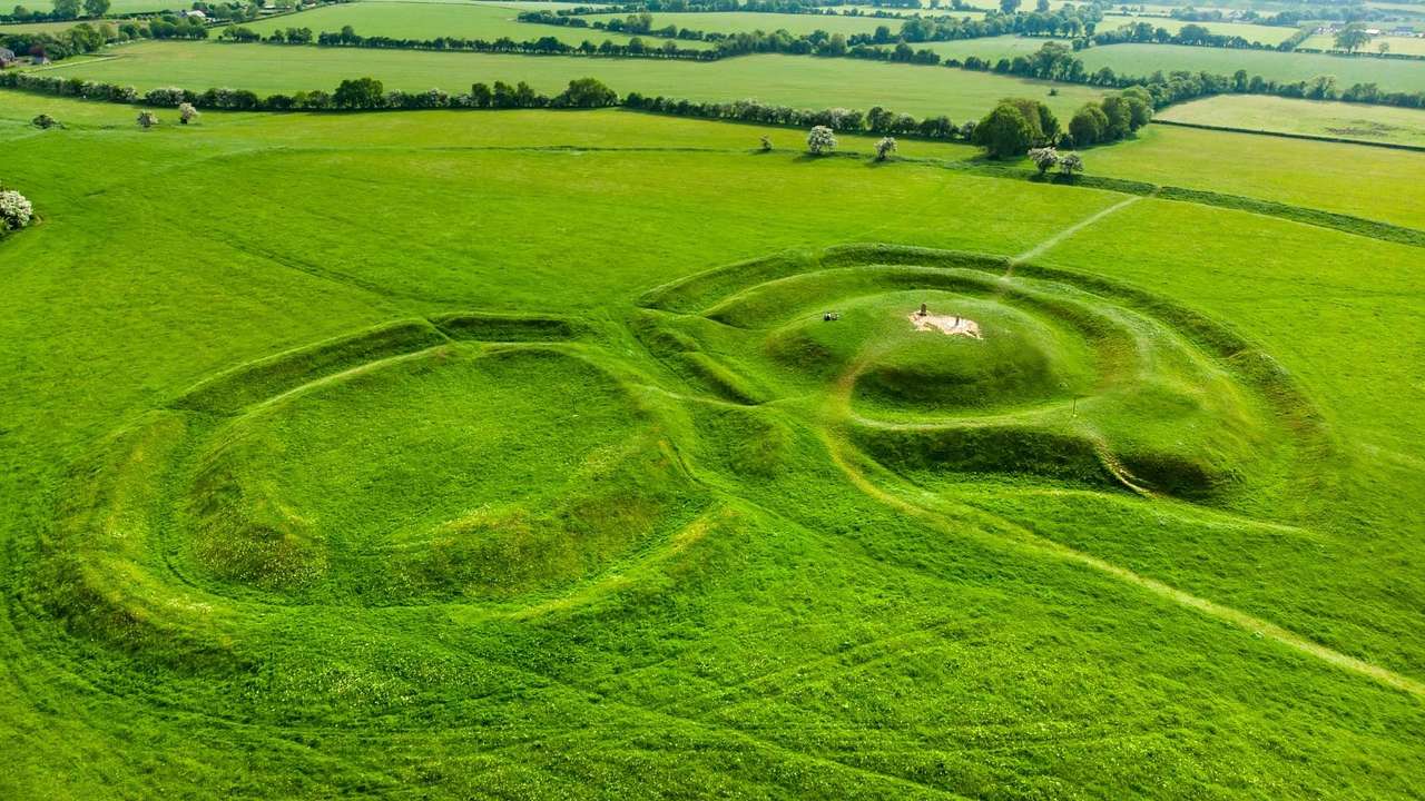 Aerial shot of a green field with circular formations
