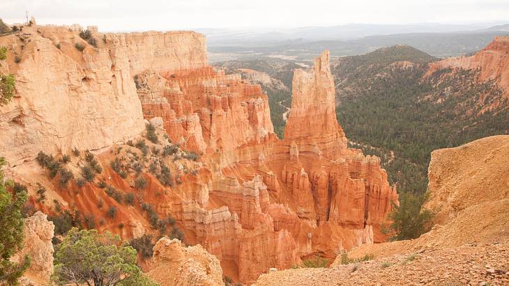 Red rock mountain range with areas of greenery