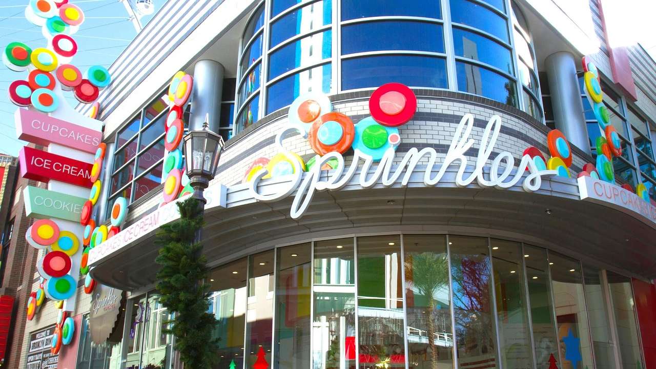 The exterior of a cupcake store with colorful decorations and a "Sprinkles" sign