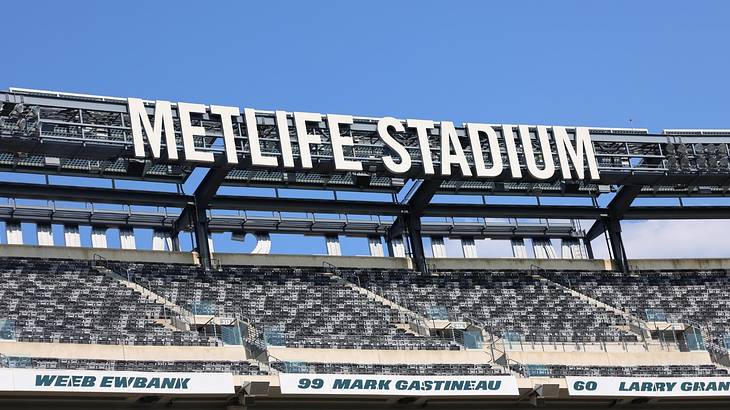The seats in a football stadium with a sign that says "MetLife Stadium" above them