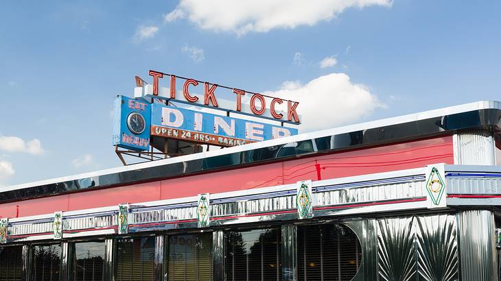 The exterior of an art deco style diner with a Tick Tock Diner signage on top