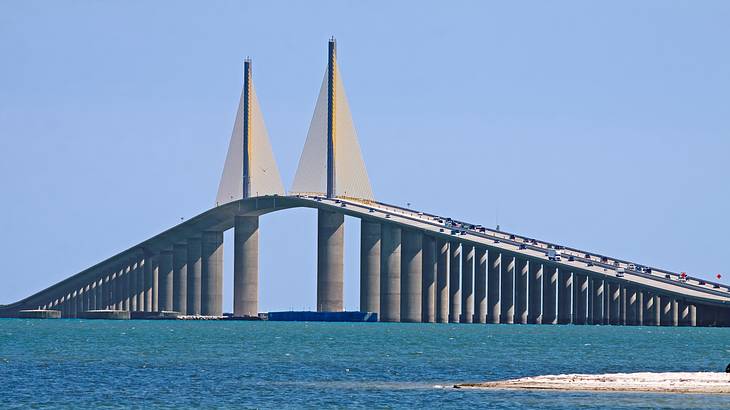 A large concrete bridge with many round concrete pillars supporting the bridge