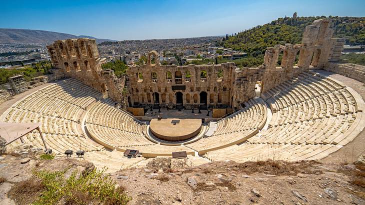 A wide aerial shot of an ancient theatre with rows of descending seats