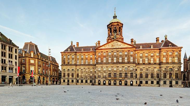 A large palace building with many windows next to a square