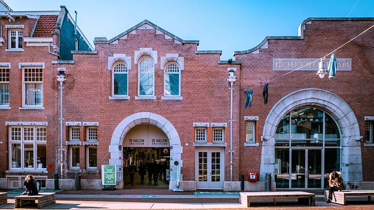 A large brick building with arched doors and windows