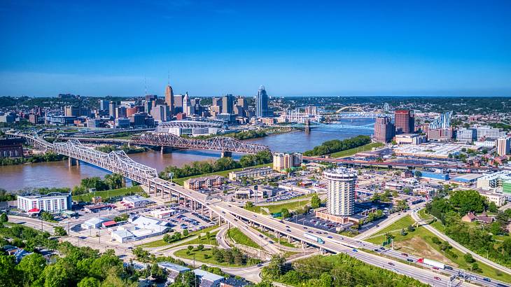 An aerial view of a city with roads and a body of water with buildings