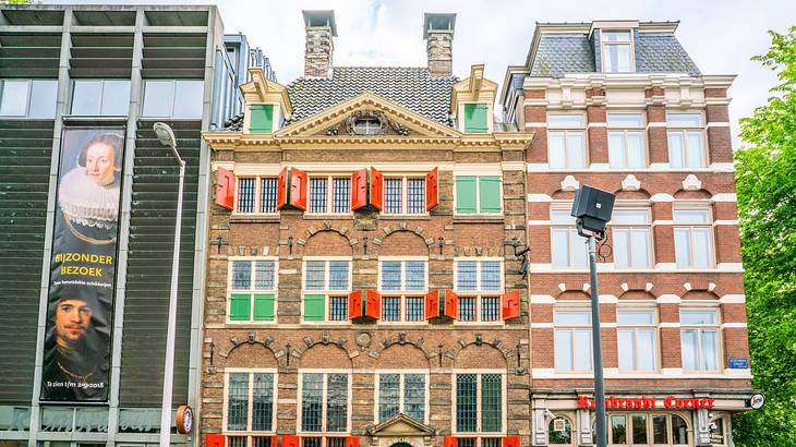 Bricked buildings with many windows and colorful shutters