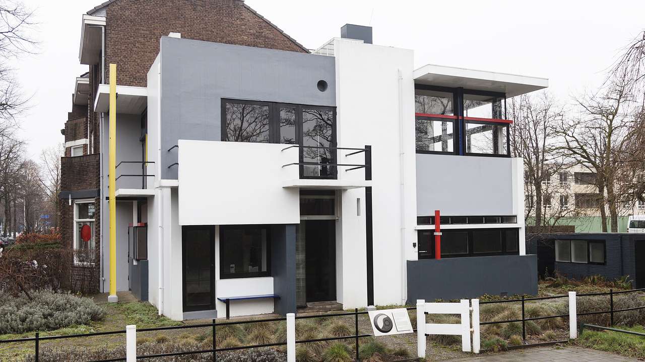 A modern house with white and grey paint and balconies