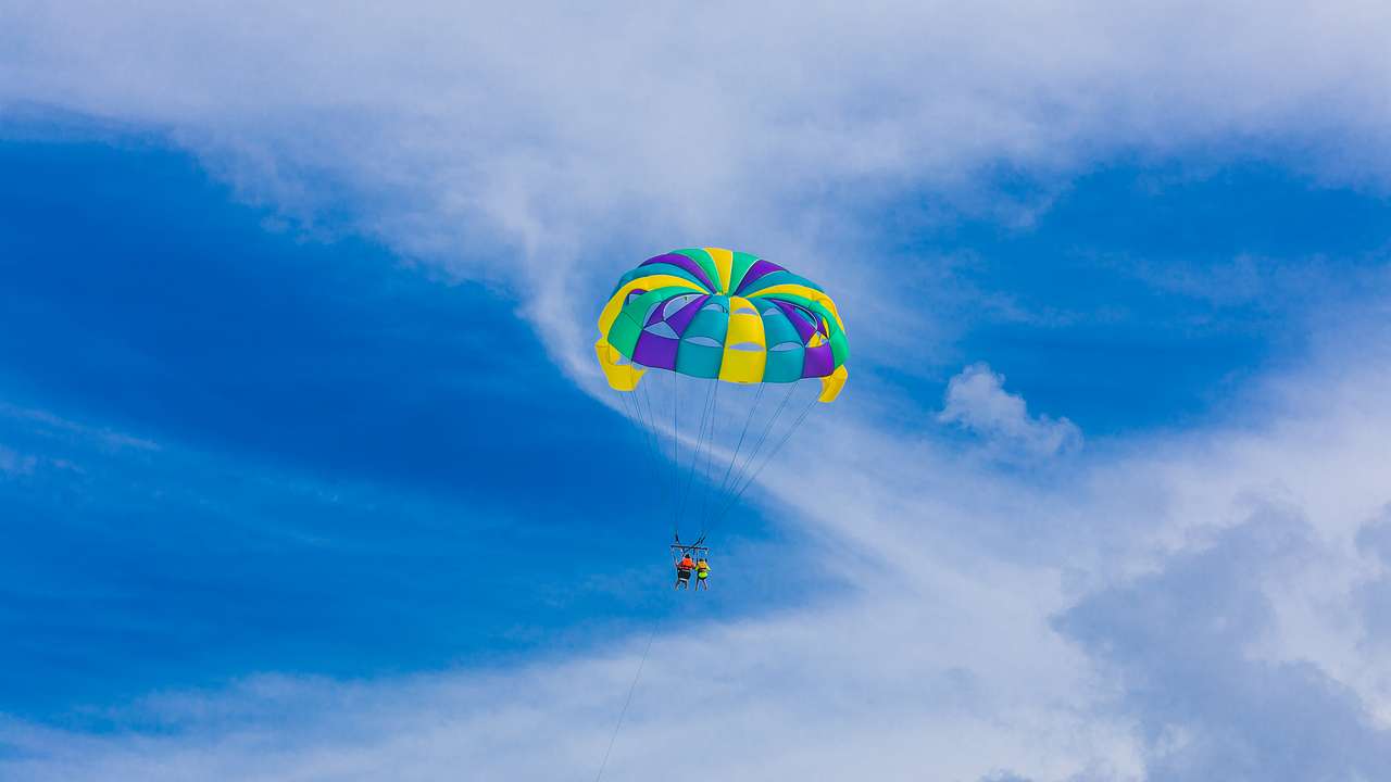 Two people parasailing in the sky