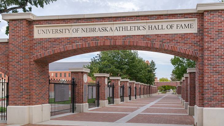 A brick entrance to a walkway that says University of Nebraska Athletics Hall of Fame