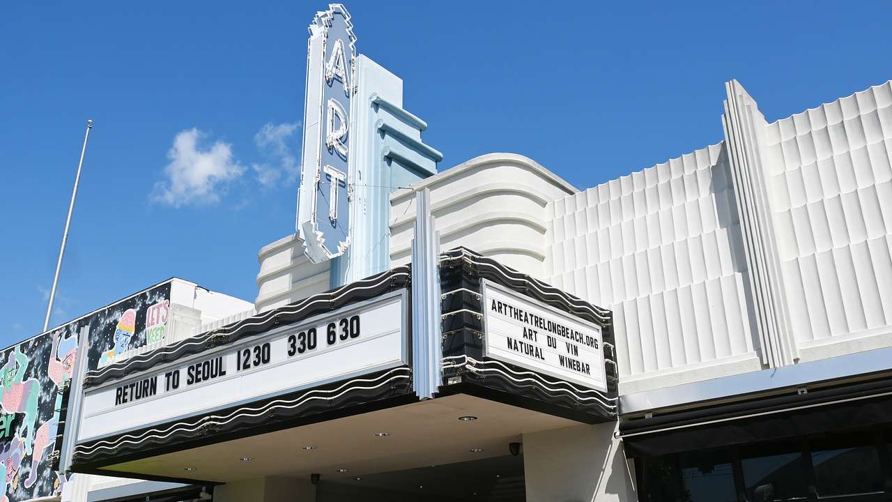 An Art Deco-style theater facade on a sunny day