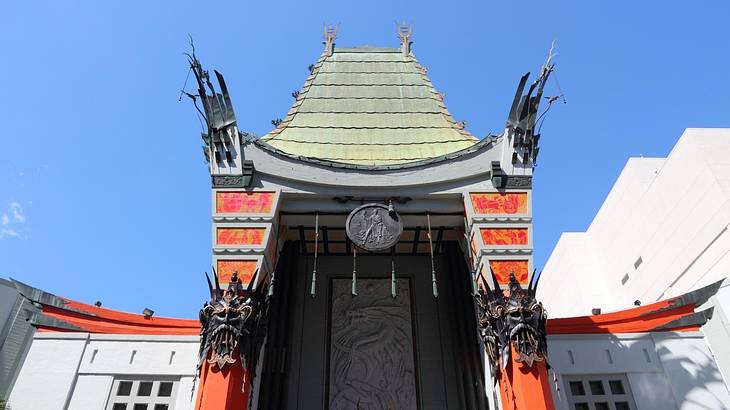 A Chinese-style entryway with red accents under a clear blue sky