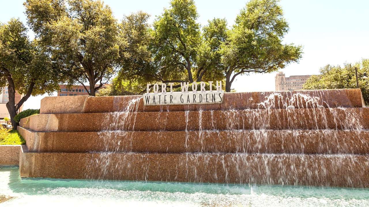 A waterfall-like feature with a "Fort Worth Water Gardens" sign