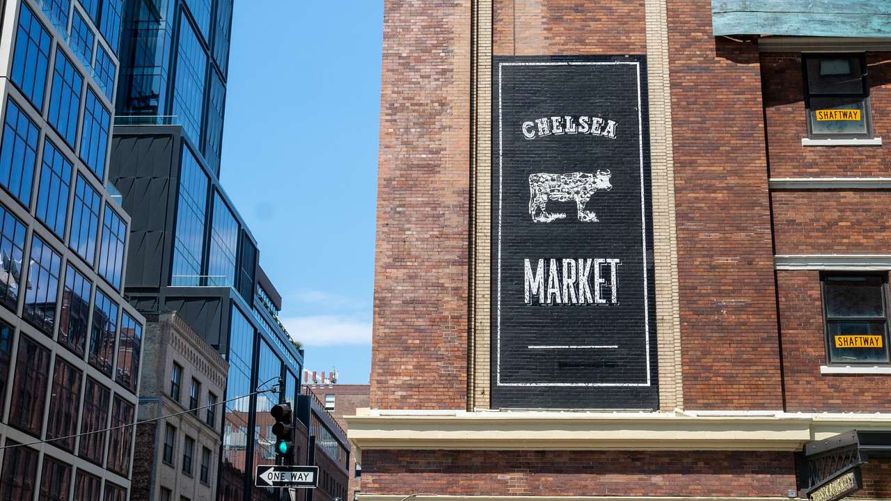 A red brick building with a sign that says "Chelsea Market"