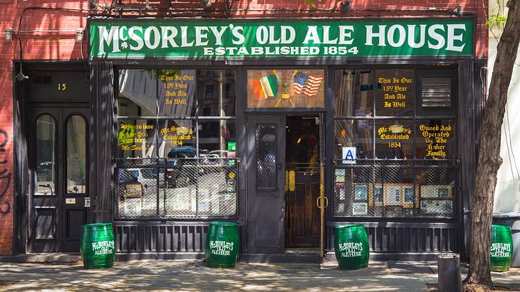 An old Irish pub with a green sign that says "McSorley's Old Ale House"
