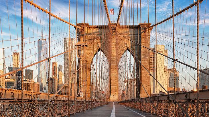 A path on a suspension bridge with a city skyline next to it