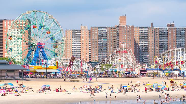 A colorful amusement park next to a beach