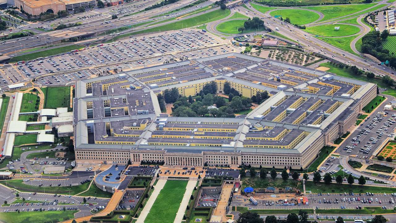 Aerial shot of a broad pentagon-shaped building surrounded by roads and structures