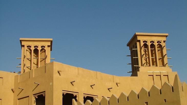 Traditional wind towers with geometric shapes from below on a sunny day Traditional wind towers with geometric shapes from below on a sunny day