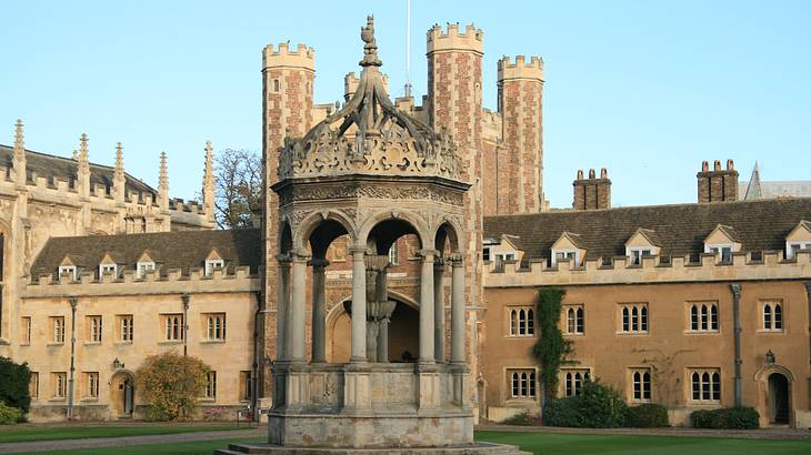 A stone gazebo in a large courtyard with several walkways and buildings around