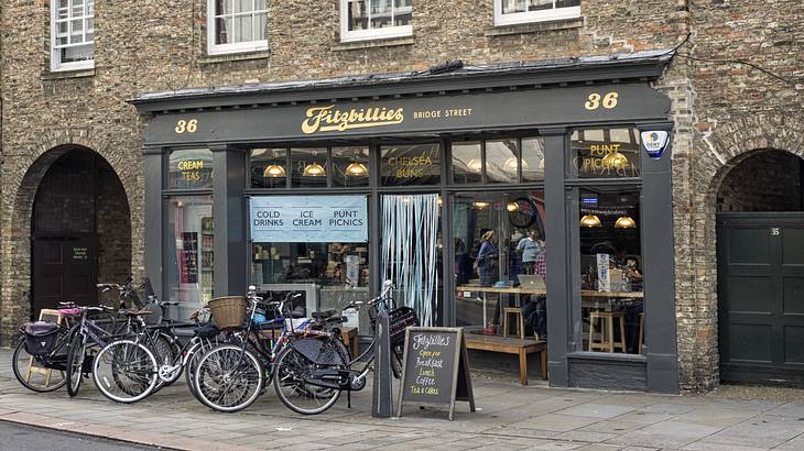 Bicycles in front of a stone building with large windows and a "Fitzbillies" sign