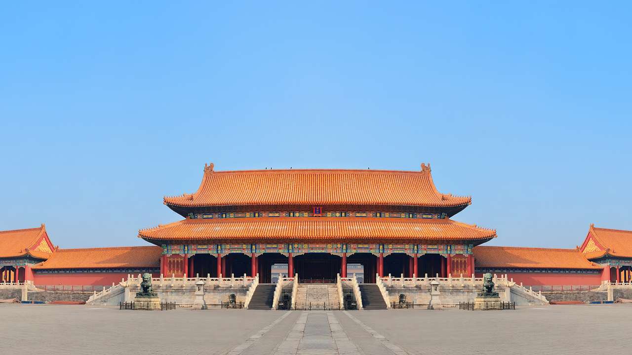 A rectangular structure with red roofs and several stairs going into the building