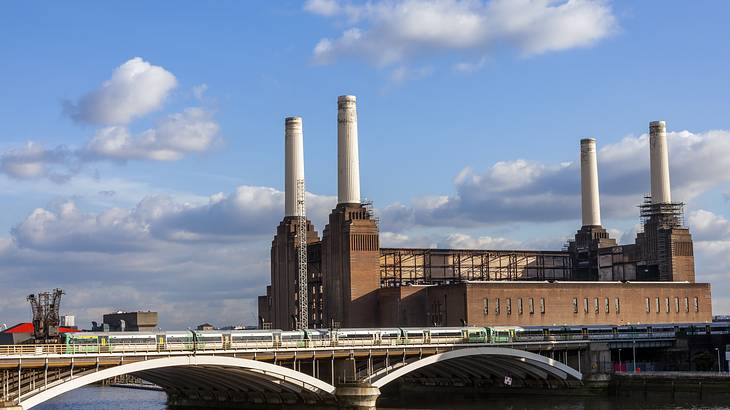 A massive coal power station with 4 large white cylinders on top, across the water