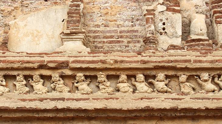Up close shot of relief carvings on a horizontal ancient wall