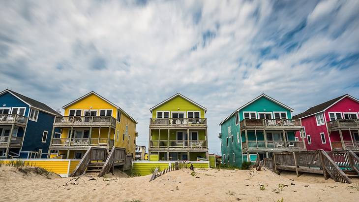 Sky above some colorful beach houses along sand