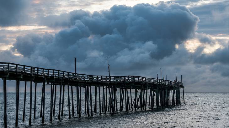 Dark, menacing clouds over a sea pier