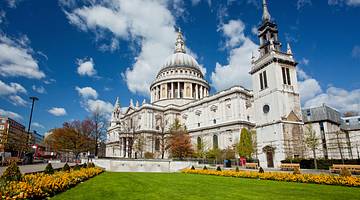 Exterior architecture of St. Paul's Cathedral behind a street and garden