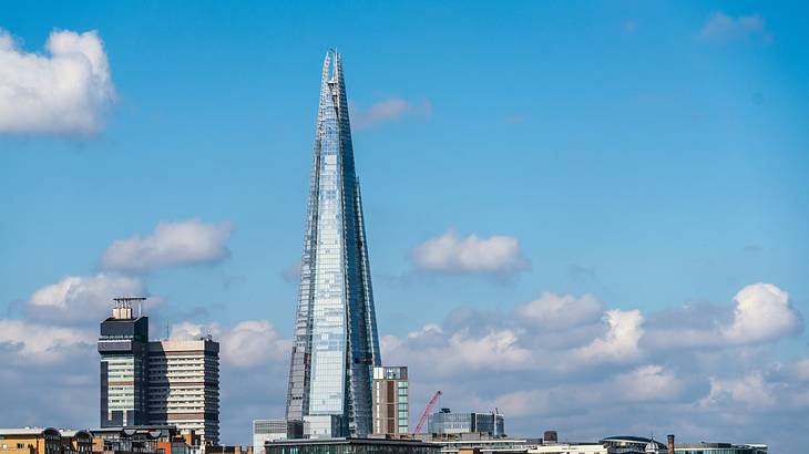 View of The Shard, a tall skyscraper, positioned behind buildings