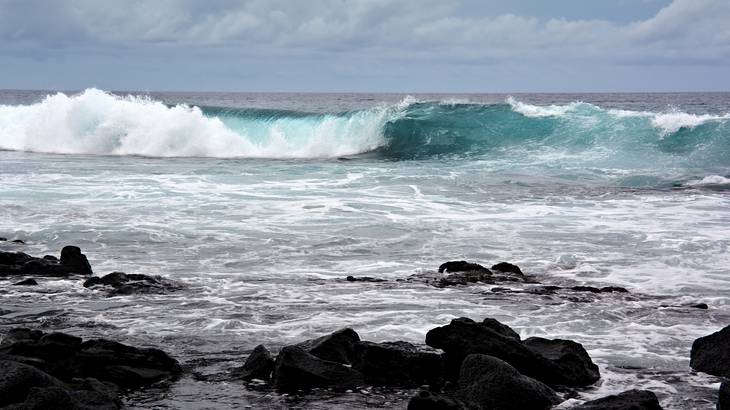 Big waves heading towards a rocky beach