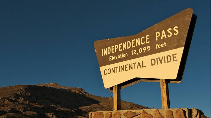 The Independence Pass signage from below with a mountain in the back