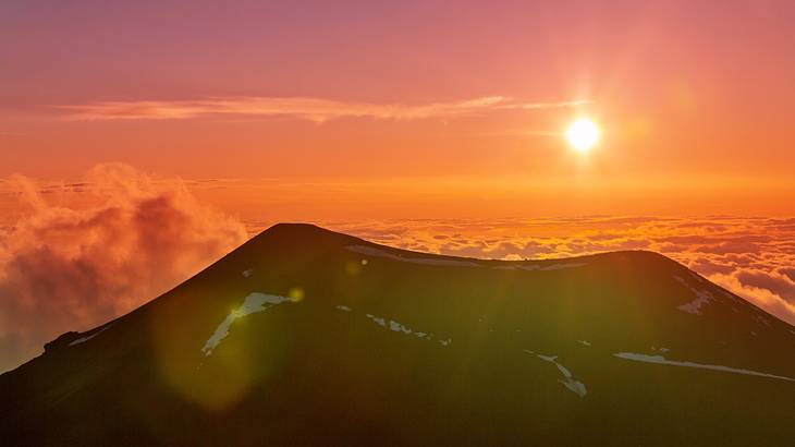 Sunset at Mauna Kea volcano top, one of the most famous landmarks in Hawaii